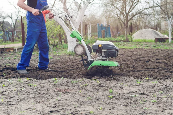 Man working in the spring garden with tiller machine — Stock Photo, Image