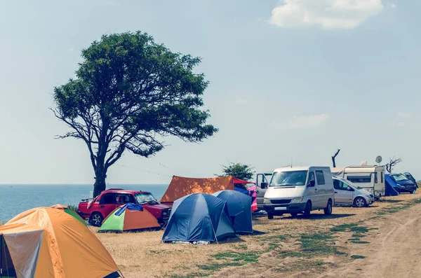 Camping site near the sea, cars and tents on the sea beach