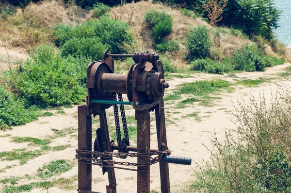 Old rusty sea winch on the shore — Stock Photo, Image
