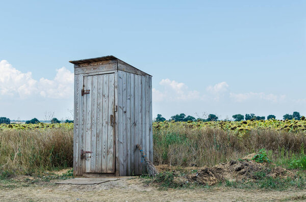 Old rural wooden toilet in the field