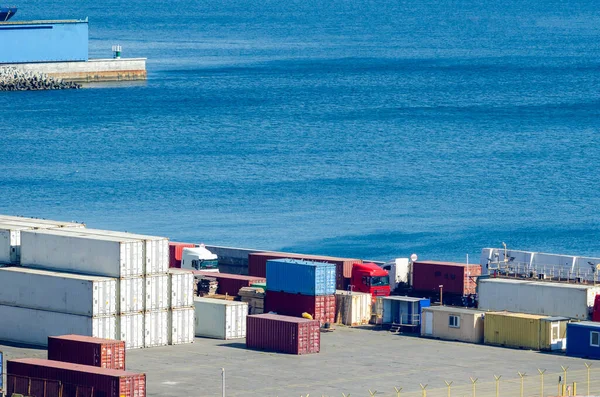 Stacked cargo containers in storage area of freight sea port — Stock Photo, Image