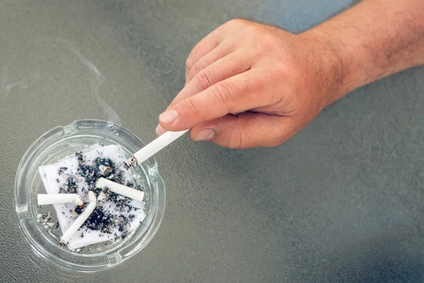 Smoker Hand Extinguishes Cigarette Butt Glass Ashtray — Stock Photo, Image
