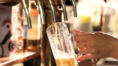 Barmen fıçı bira dolduruyor.