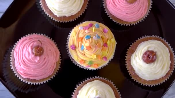 Cupcakes with icing small appetizing desserts with cherry on top — Stock Video