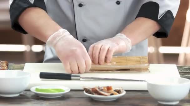 Χέρια κάνοντας σούσι μπαμπού μάτ σεφ κάνοντας γιαπωνέζικο φαγητό — Αρχείο Βίντεο