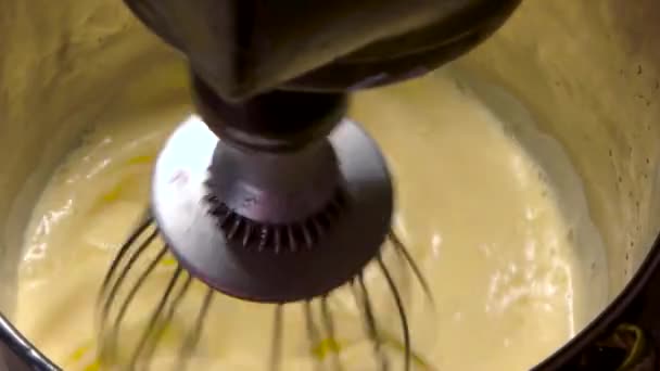 Whisking egg yolks and sugar in a bowl slow motion mixing — Stock Video