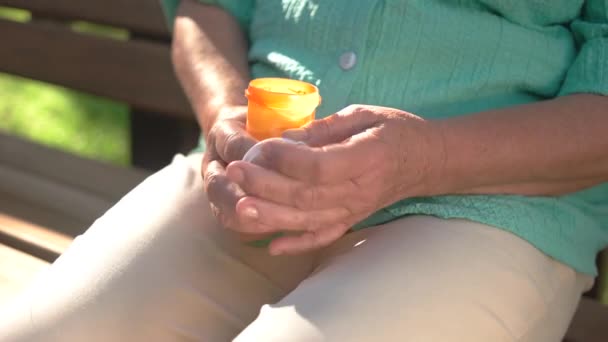 Female hands holding pill bottle container with medicine — Stock Video