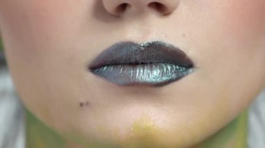 Koyu dudaklar genç bir kadının seksi dudaklarını kapatır.