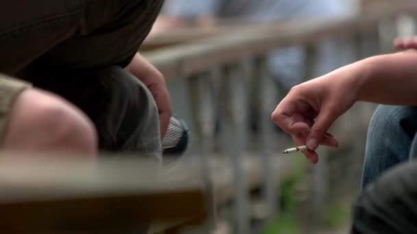 Hand holding a smoking cigarette smoking kills close up — Stock Video