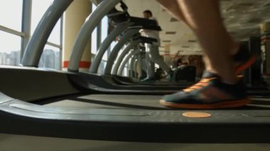 Spor salonundaki koşu bandı sporcuları spor salonunda çalışıyor.
