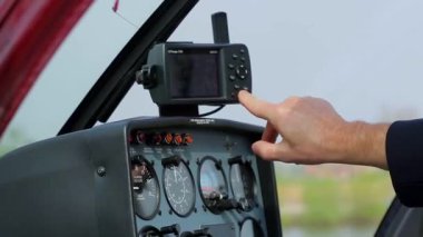 Pilot, helikopterin kontrol panelini ayarlar.