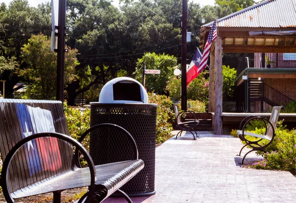 Park bench with Texas flag painted on the back in Montgomery, TX.