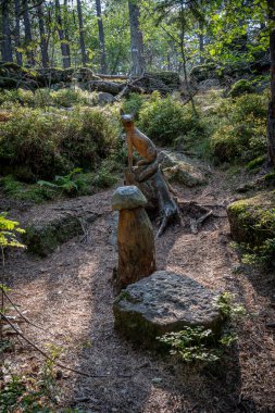 Mont Sainte Odile, France - 09 11 2020: Path of the Gauls. View of a wooden sculpture of a fox and a mushroom clipart