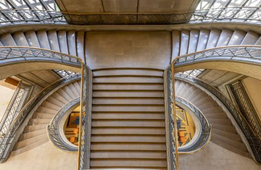 Paris, France - 09 09 2025: Palais d'Iena. Top view of the monumental double-spiral staircase, in the shape of a heart or horseshoe, and its banister created by the ironworker Raymond Subes