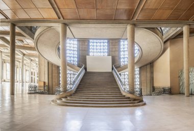 Paris, France - 09 09 2025: Palais d'Iena. Front view of the monumental double-spiral staircase, in the shape of a heart or horseshoe, and its banister created by the ironworker Raymond Subes