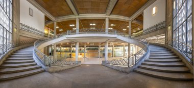 Paris, France - 09 09 2025: Palais d'Iena. Front view of the monumental double-spiral staircase, in the shape of a heart or horseshoe, and its banister created by the ironworker Raymond Subes