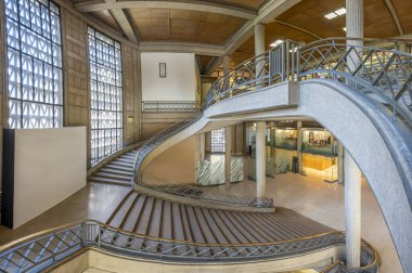 Paris, France - 09 09 2025: Palais d'Iena. Side view of the monumental double-spiral staircase, in the shape of a heart or horseshoe, and its banister created by the ironworker Raymond Subes