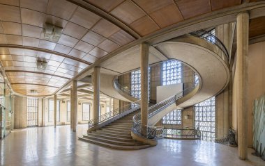 Paris, France - 09 09 2025: Palais d'Iena. Side view of the monumental double-spiral staircase, in the shape of a heart or horseshoe, and its banister created by the ironworker Raymond Subes