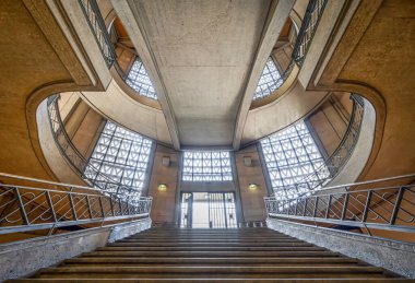 Paris, France - 09 09 2025: Palais d'Iena. Front view of the monumental double-spiral staircase, in the shape of a heart or horseshoe, and its banister created by the ironworker Raymond Subes
