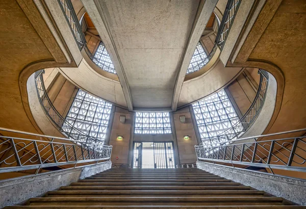 Paris, France - 09 09 2025: Palais d'Iena. Front view of the monumental double-spiral staircase, in the shape of a heart or horseshoe, and its banister created by the ironworker Raymond Subes