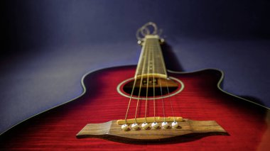 Görüntünün ortasında yatan güzel ve renkli elektroakustik bir gitarın portresi köprüyü, ağzı, boynu ve tellerini gösteriyor. Müzikal altyapılar için ideal.