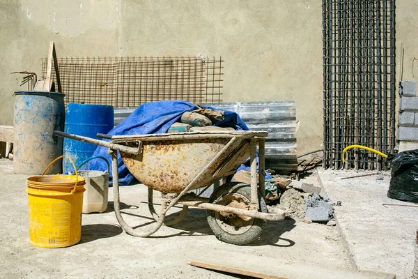 Wheel, old, bucket, tool, wood, tire, barrel, dirty, no person, concrete mixer, forge, chair, container, table, cart, automotive tire, sitting, machine, plant, room, small, helmet, industry, area, hardhat, wooden, brick, rusty, living, worker, agricu — Stock Image Wheel Old Bucket Tool Wood Tire Barrel Dirty Person Concrete Stock Photo