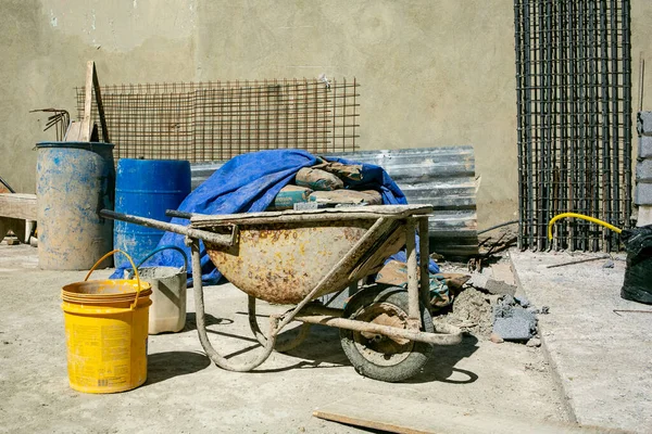 Wheel, old, bucket, tool, wood, tire, barrel, dirty, no person, concrete mixer, forge, chair, container, table, cart, automotive tire, sitting, machine, plant, room, small, helmet, industry, area, hardhat, wooden, brick, rusty, living, worker, agricu — Stock Image Wheel Old Bucket Tool Wood Tire Barrel Dirty Person Concrete Stock Image