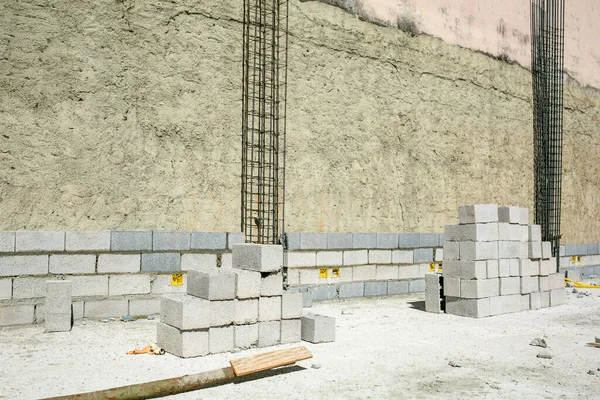 wall, brick, concrete, granite, cement, building, stone, stone wall, sidewalk, tile, limestone, architecture, cobblestone, rock, walkway, path, artifact, slate, no person, brickwork, sitting, cube, bench, table, rough, flooring, man, rug, expression,