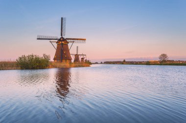 Windmill reflected in the canal Kinderdijk Rotterdam South Holland Netherland Europe clipart