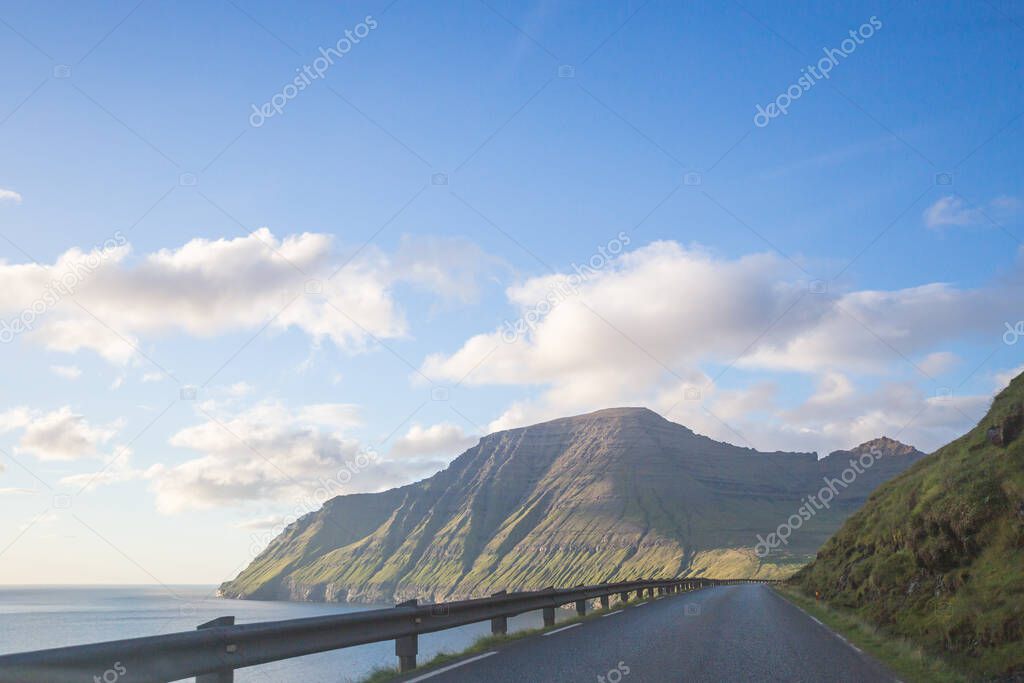 Winding coastal road leading to Sorvagur on the island of Vagar, Faroe Islands, Europe