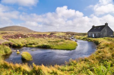 A cottage perched on the Isle of North Uist in the Outer Hebrides in Scotland. High quality photo clipart