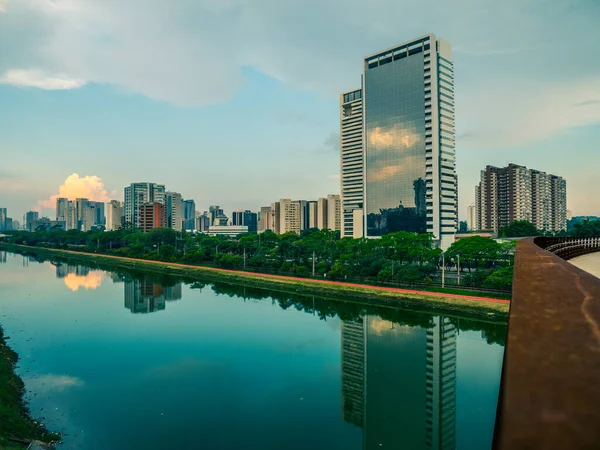 Empty Piinheiros River, bike lane, trees and office buildings