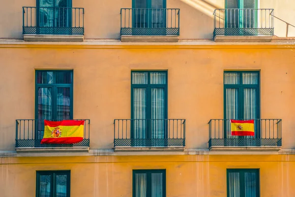 Pencereler ve İspanyol bayrakları ile ön cephe.