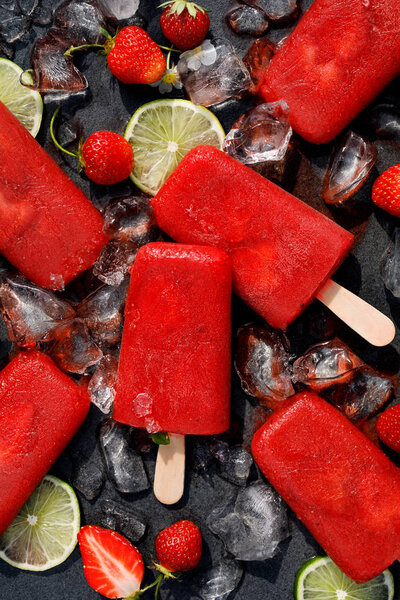Ice popsicles. Strawberry ice pops, delicious and healthy homemade dessert, perfect for hot summer days, top view.