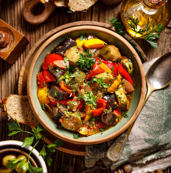 Ratatouille, Vegetarian stew made of zucchini, eggplants, peppers, onions, garlic and tomatoes with addition of aromatic herbs, top view. Traditional french food, vegetable dish