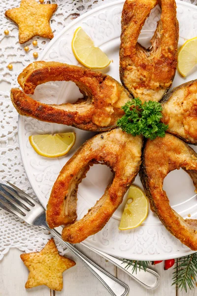Fried carp fish slices on a white plate, top view. Traditional christmas eve dish. Polish christmas — Stock Image Fried Carp Fish Slices White Plate Top View Traditional Christmas Royalty Free Stock Images