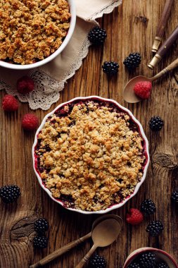 Crumble, Karışık berry (böğürtlen, ahududu) ufalamak, haşlanmış meyve yulaf ezmesi, badem unu, tereyağı ve şeker bir fırın kabında bir fırın kabında ufalanmış tepesinde, üst görünümü