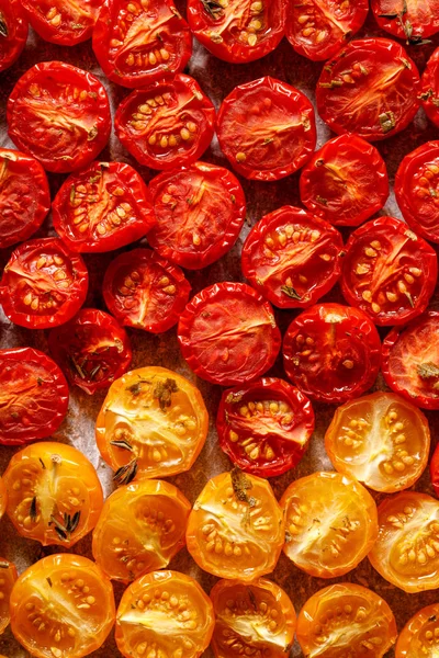 Sun dried tomatoes, dried red and yellow cherry tomatoes, close up, top view. Sun dried tomato background.