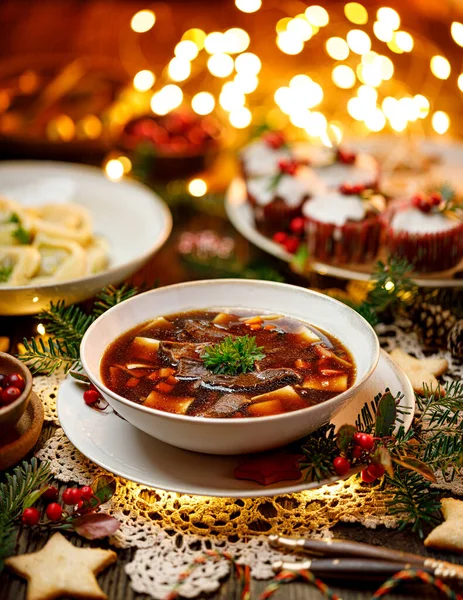 Christmas mushroom soup, a traditional vegetarian mushroom soup made with dried forest mushrooms in a ceramik plate on a festive table. Polish Christmas dinner — Stock Image Christmas Mushroom Soup Traditional Vegetarian Mushroom Soup Made Dried Forest Royalty Free Stock Images