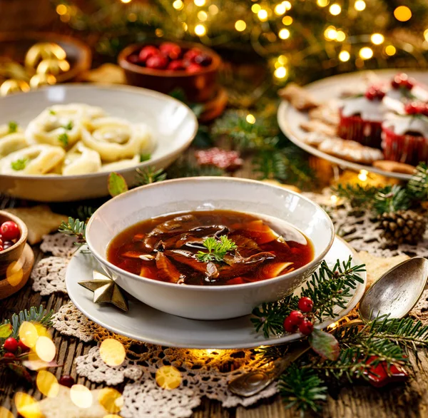 Christmas mushroom soup, a traditional vegetarian mushroom soup made with dried forest mushrooms in a ceramik plate on a festive table. Polish Christmas dinner — Stock Image Christmas Mushroom Soup Traditional Vegetarian Mushroom Soup Made Dried Forest Royalty Free Stock Images