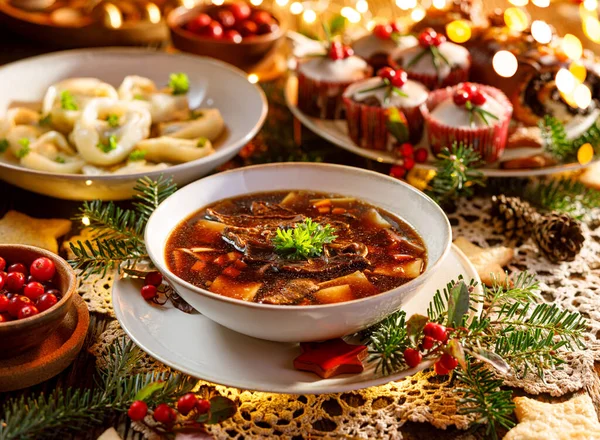 Christmas mushroom soup, a traditional vegetarian mushroom soup made with dried forest mushrooms in a ceramik plate on a festive table. Polish Christmas dinner — Stock Image Christmas Mushroom Soup Traditional Vegetarian Mushroom Soup Made Dried Forest Royalty Free Stock Photos