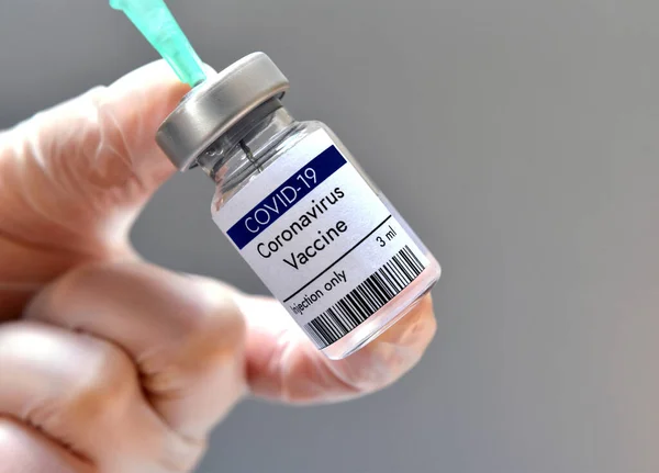 Coronavirus vaccine vial against COVID-19 virus at Moderna, Pfizer laboratory USA. Close-up.