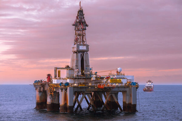 NORTH SEA, NORWAY - 2015 MAY. Beautiful sunset at offshore at oil rig Transocean Prospect and offshore vessel KL Sandefjord in North Sea.