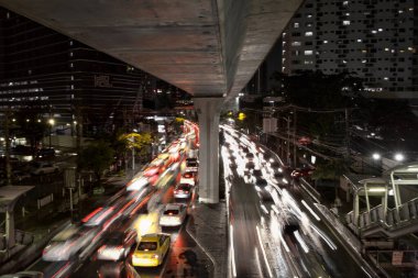 BANGKOK, THAILAND - 15 Temmuz 2020: Gökyüzü tren istasyonunun altındaki Sukhumvit yolu üzerinde bir şehir. Her gece yoğun trafik var. Özellikle de yağmur yağmaya başladığında..