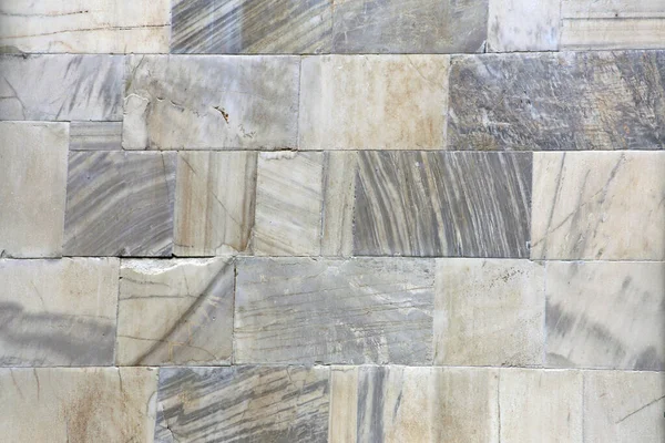 Natural marble stone wall.Wall of fine stone tiles for wallpaper.12th century marble cubes.