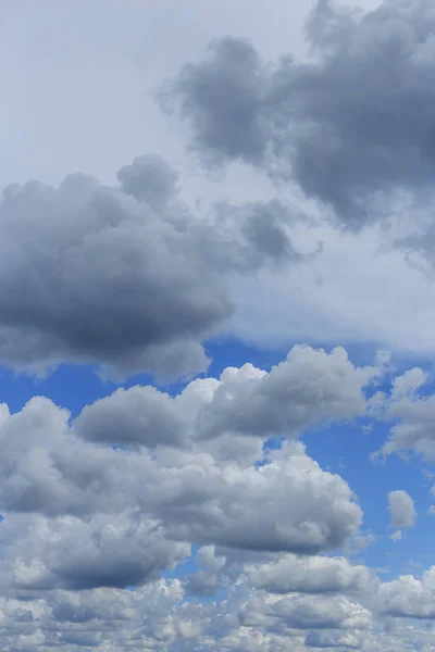 white and gray clouds, densely covering the blue sky as a natural background