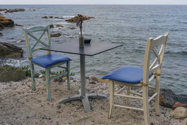 Fragment of the coastal cafe on the background of the blue sea
