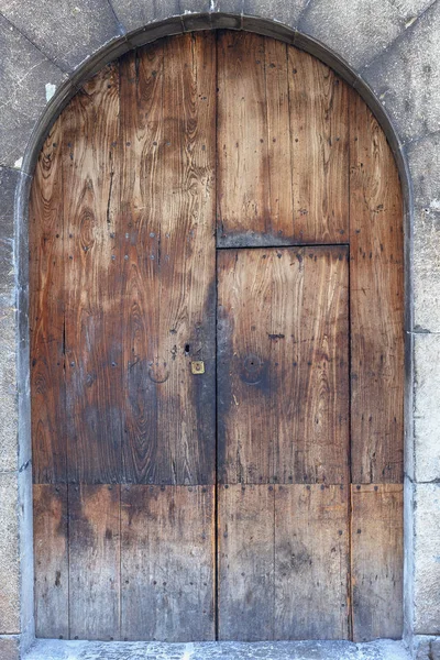 simple wooden door in an old stone wall close-up