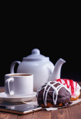 taze lezzetli donuts ve karanlık bir arka plan üzerinde çay