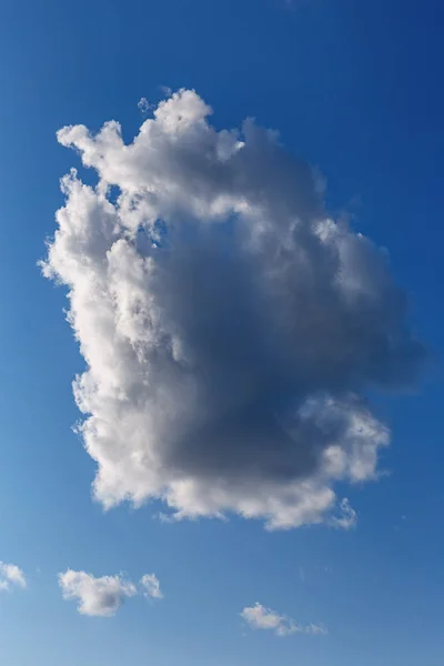 blue sky with a big white cloud in the foreground